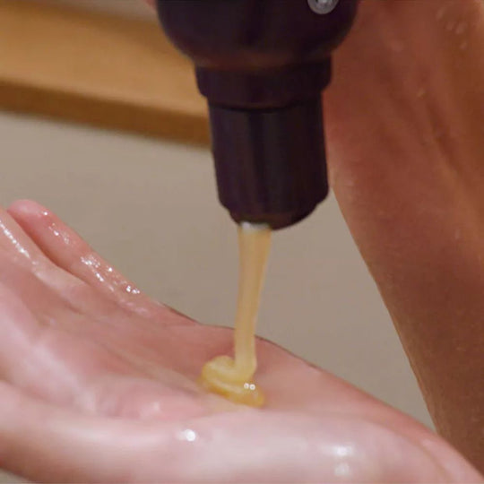 Aveda Invati Ultra Advanced Exfoliating Shampoo Rich being dispensed onto a hand.