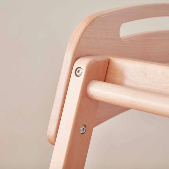 Close-up of a wooden chair with a neutral background