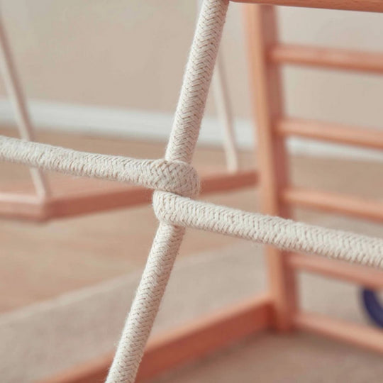 Close-up of a pink chair with rope detailing on a blurred background