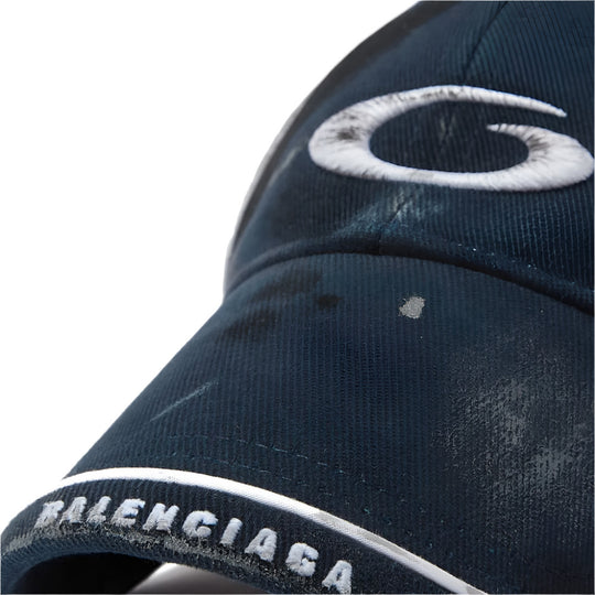 Close up view of the embroidery on Balenciaga Men's Loop Sports Icon Distressed Cotton Drill Cap