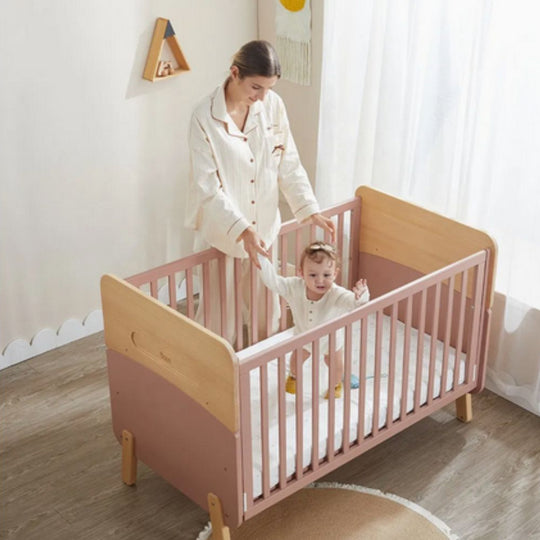 Woman and child in Boori Neat 5-in-1 Convertible Cot in a bright room