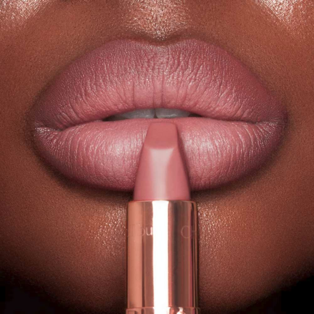A close-up shot features a person applying Charlotte Tilbury Matte Revolution Lipstick.