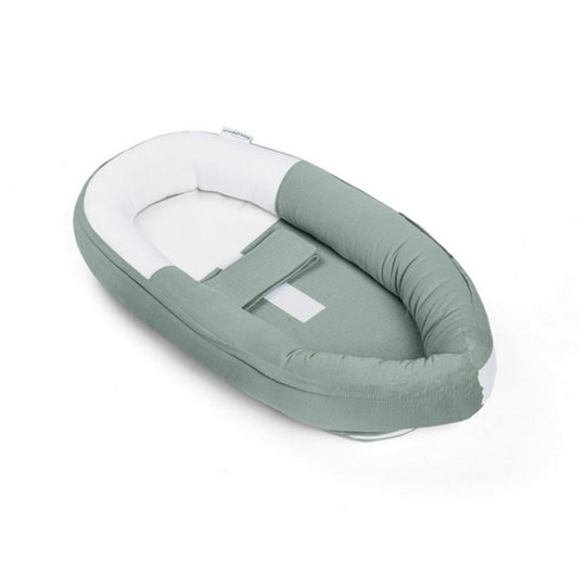 Green and white baby nest on a white background