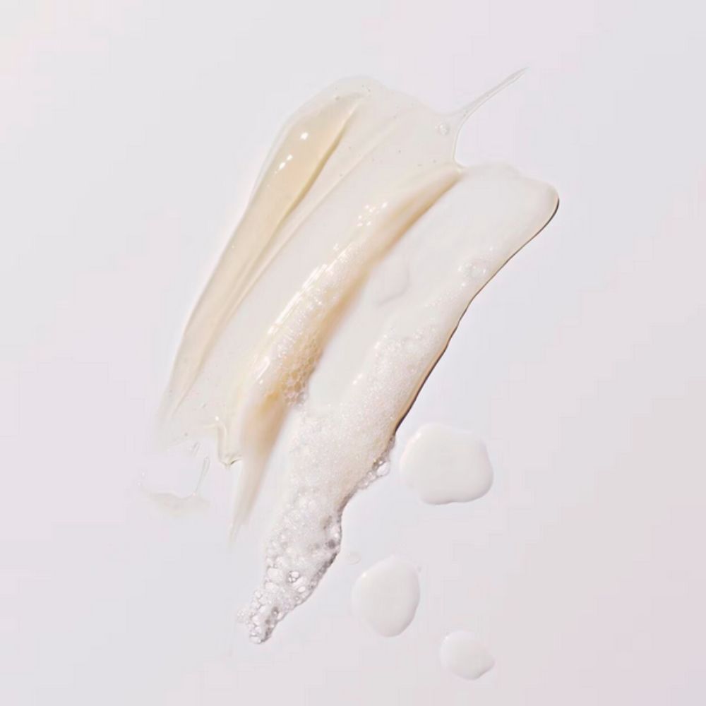 Creamy, off-white skincare product swatches of FENTY SKIN Melt Awf - Jelly Oil Makeup-Melting Cleanser