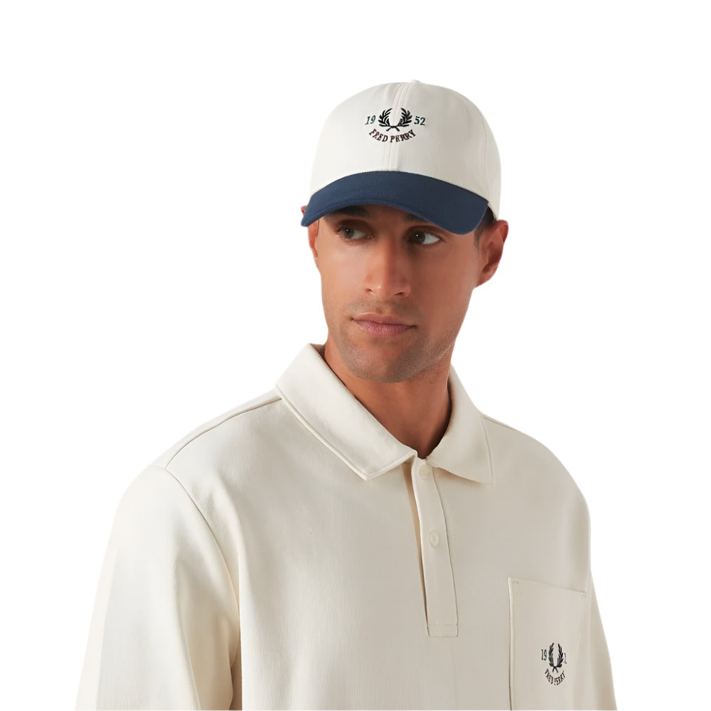 A model wearing Fred Perry Classic Cotton Piqué Baseball Cap with 1952 Graphic and Laurel Wreath embroidery