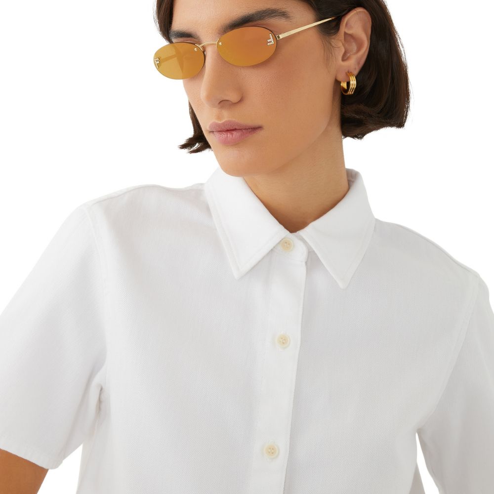 A model wearing  Fendi First Women's Gold Oval Sunglasses with Crystal Detailing
