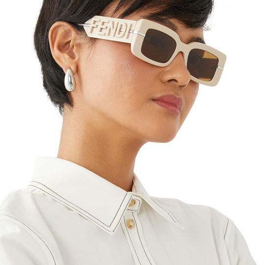A model wearing Fendi Women's Fendigraphy Beige Rectangular Sunglasses