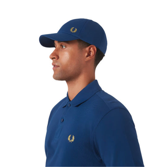 A model wearing Fred Perry Classic Cotton Piqué Blue Baseball Cap with Laurel Wreath embroidery