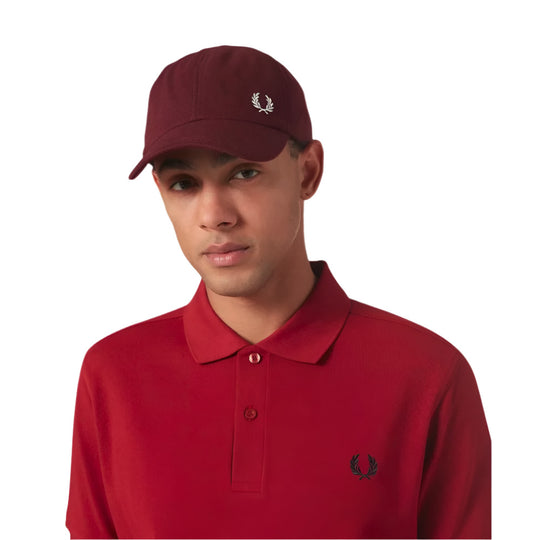 A model wearing Fred Perry Classic Cotton Piqué Burgundy Baseball Cap with Laurel Wreath embroidery
