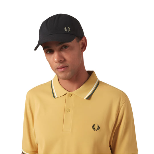 A model wearing Fred Perry Classic Cotton Piqué Dark Grey Baseball Cap with Laurel Wreath embroidery