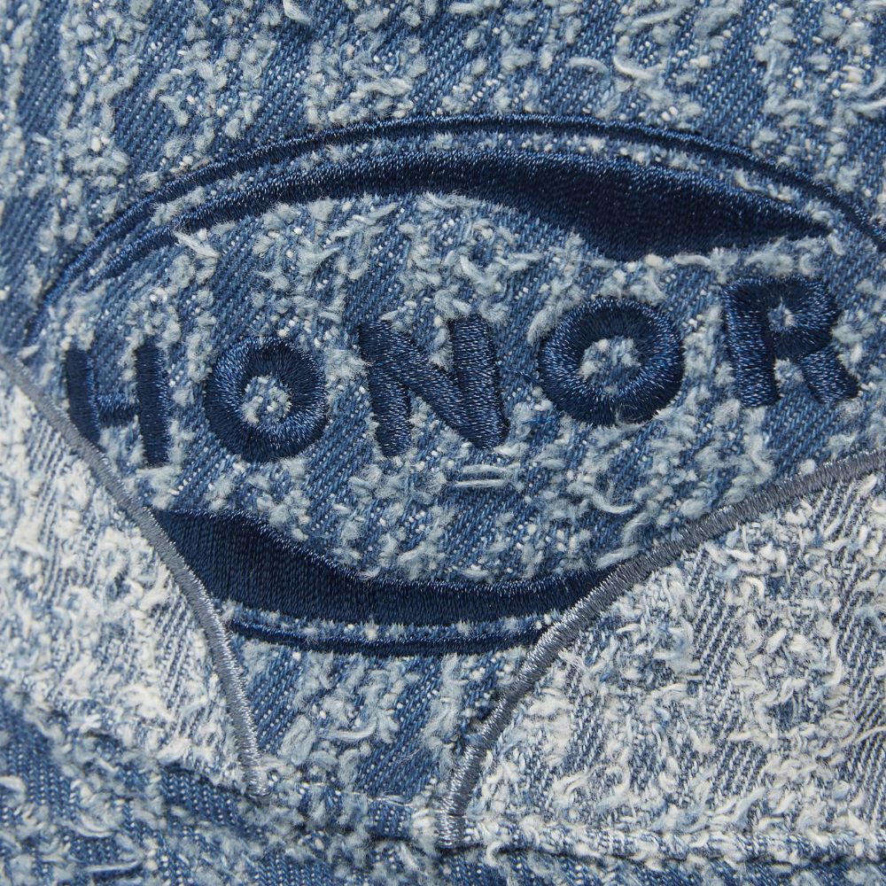 Detail of the Honor The Gift Groove Panelled Bucket Hat, showing the logo patch