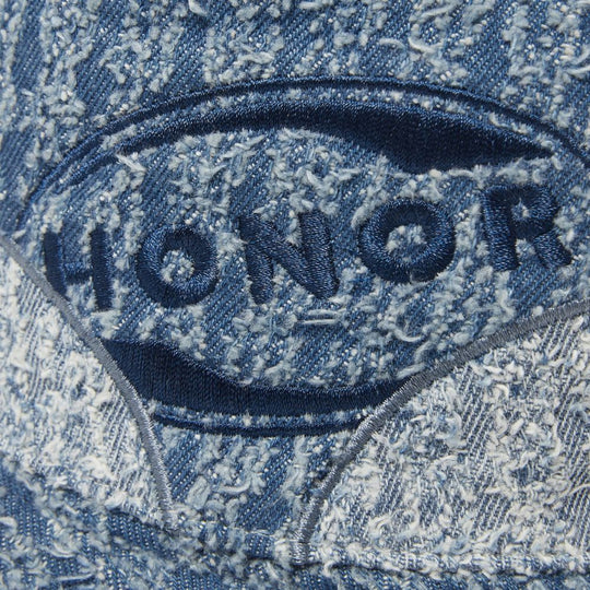Detail of the Honor The Gift Groove Panelled Bucket Hat, showing the logo patch