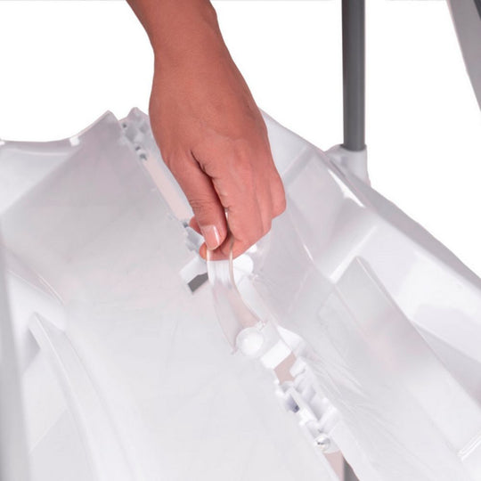 Hand holding a white plastic bag against a white background