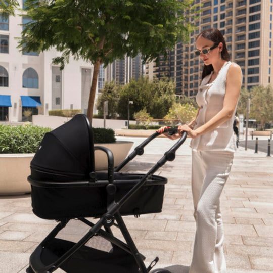Woman pushing a Jikel CityFlex stroller in an urban setting