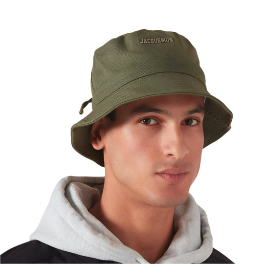 A model wearing Jacquemus Le Bob Gadjo Dark Green Bucket Hat with Drawstring