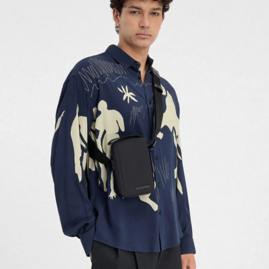 A male  model wearing Jacquemus The Vertical Cuerda Denim Black Cross-Body Bag