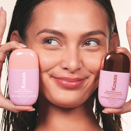 A model showing 2 packs of Kosas DreamBeam Smoothing Makeup Base SPF30 - The original and Sunlit version