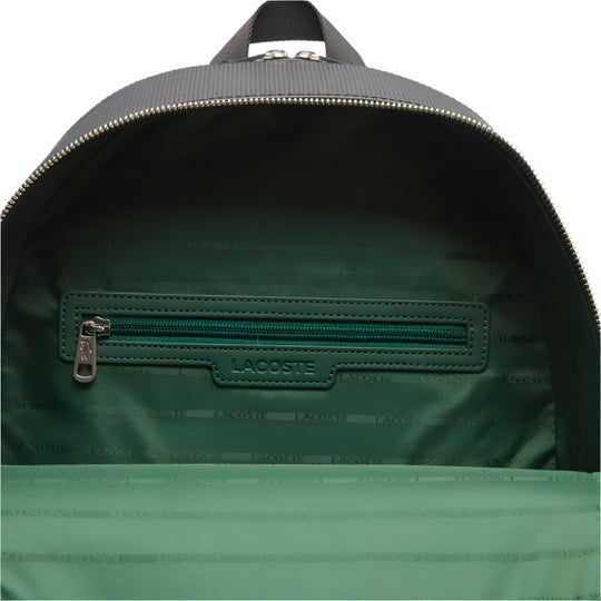 A close-up shot of the open main compartment of a LACOSTE Chantaco Pique Leather Black Backpack