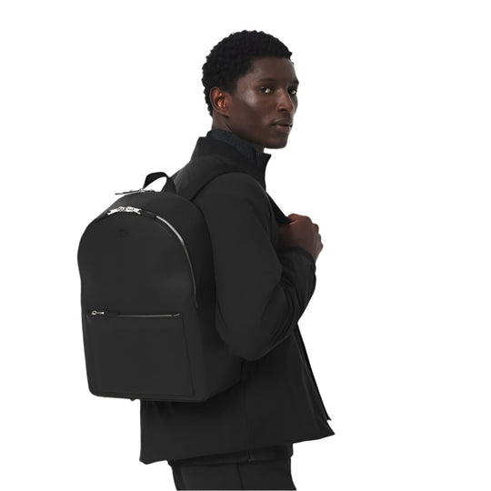 A model with LACOSTE Chantaco Pique Leather Black Backpack on his back