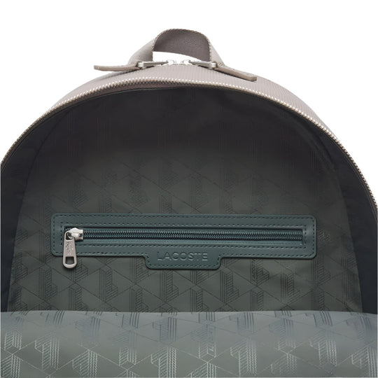 A close-up shot of the open main compartment of a LACOSTE Chantaco Pique Leather Brown Backpack