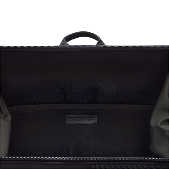 A close-up view inside an open Blue backpack reveals a zippered main compartment, a mesh pocket, and a flat inner pocket.