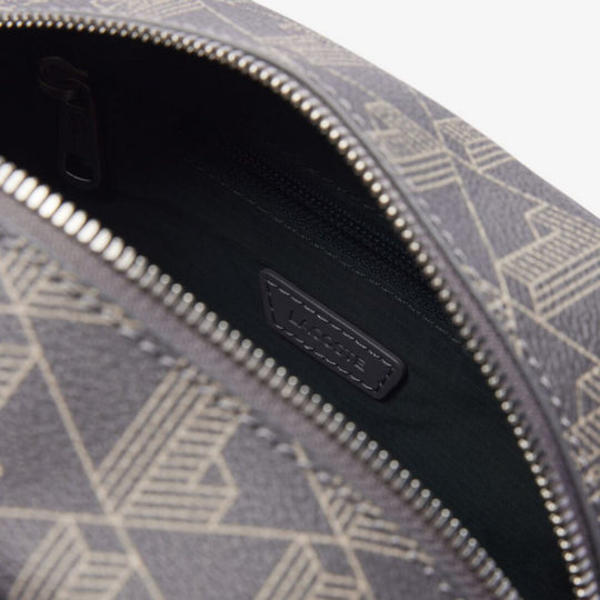 Close-up shot of the open LACOSTE The Blend Toiletry Bag, revealing its dark grey interior lining and a debossed "LACOSTE" logo patch on the inside wall.