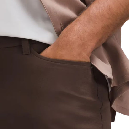 LULULEMON ABC Warpstreme Slim-Fit 5 Pocket Pants  with a hand in the pocket.