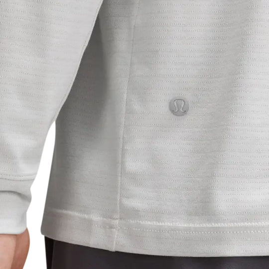 Close up view of hem of LULULEMON License To Train Relaxed Long Sleeve T-Shirt worn by a male model