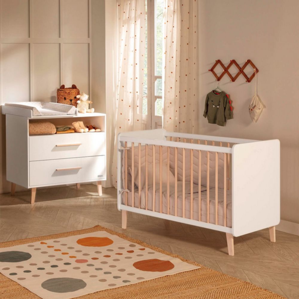 Nursery room with white crib and Micuna Trevi Dresser CO-1959 , wooden floor, and decorative rug.