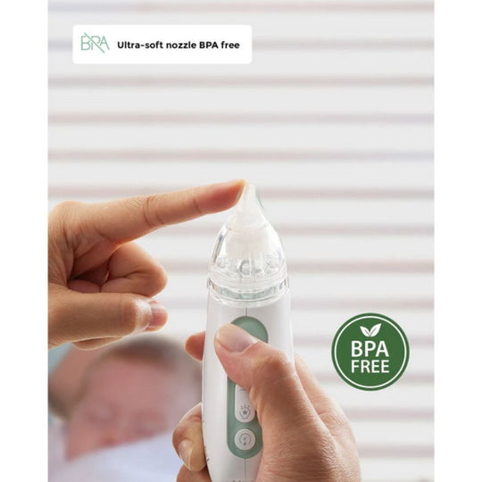 Momcozy Quiet Rechargeable Baby Nasal Aspirator with BPA-free label held by a hand, with a blurred background.