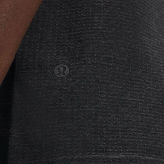 Close up view of hem of LULULEMON Metal Vent Tech Sleeveless Vest worn by a male model