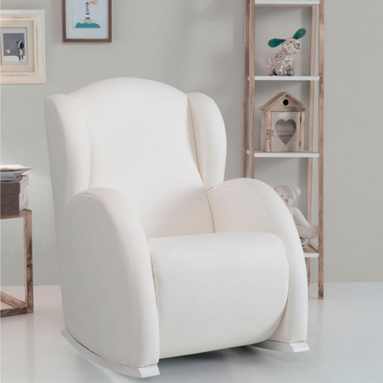 Micuna Flor Slow System Rocking Chair in a room with a wooden shelf and decorative items.