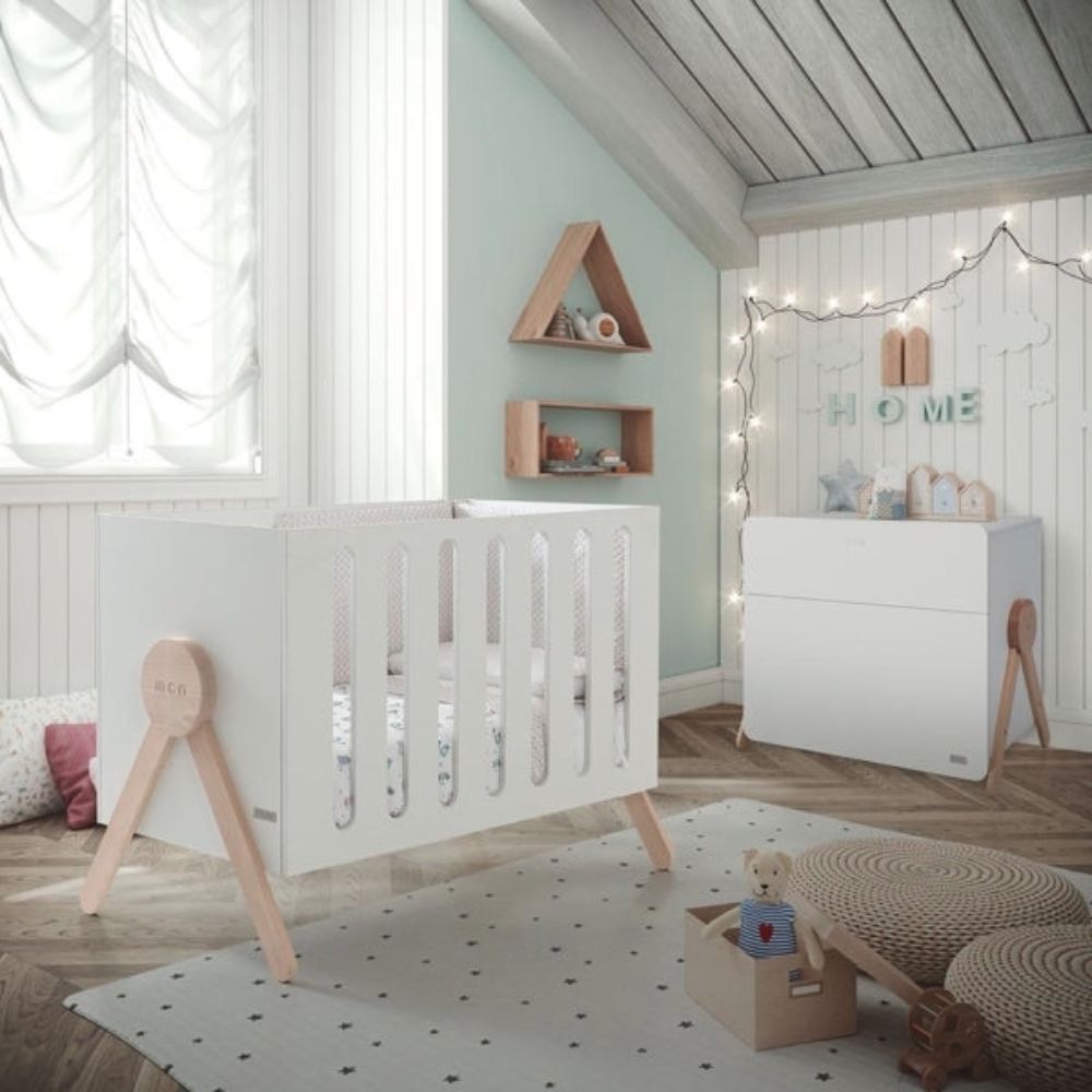 Nursery room with a Micuna Premium Swing Cot, shelves, and decorative elements.