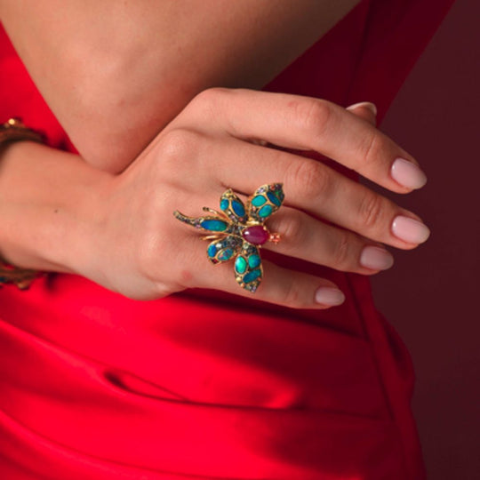Close up of Moiseau Whispering Angel Ring on a lady's finger