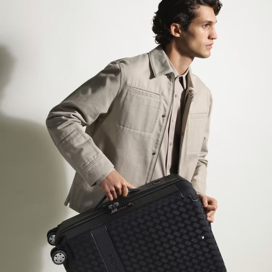 Man holding Montblanc MY4810 Luxury Cabin Trolley Bag against a plain background