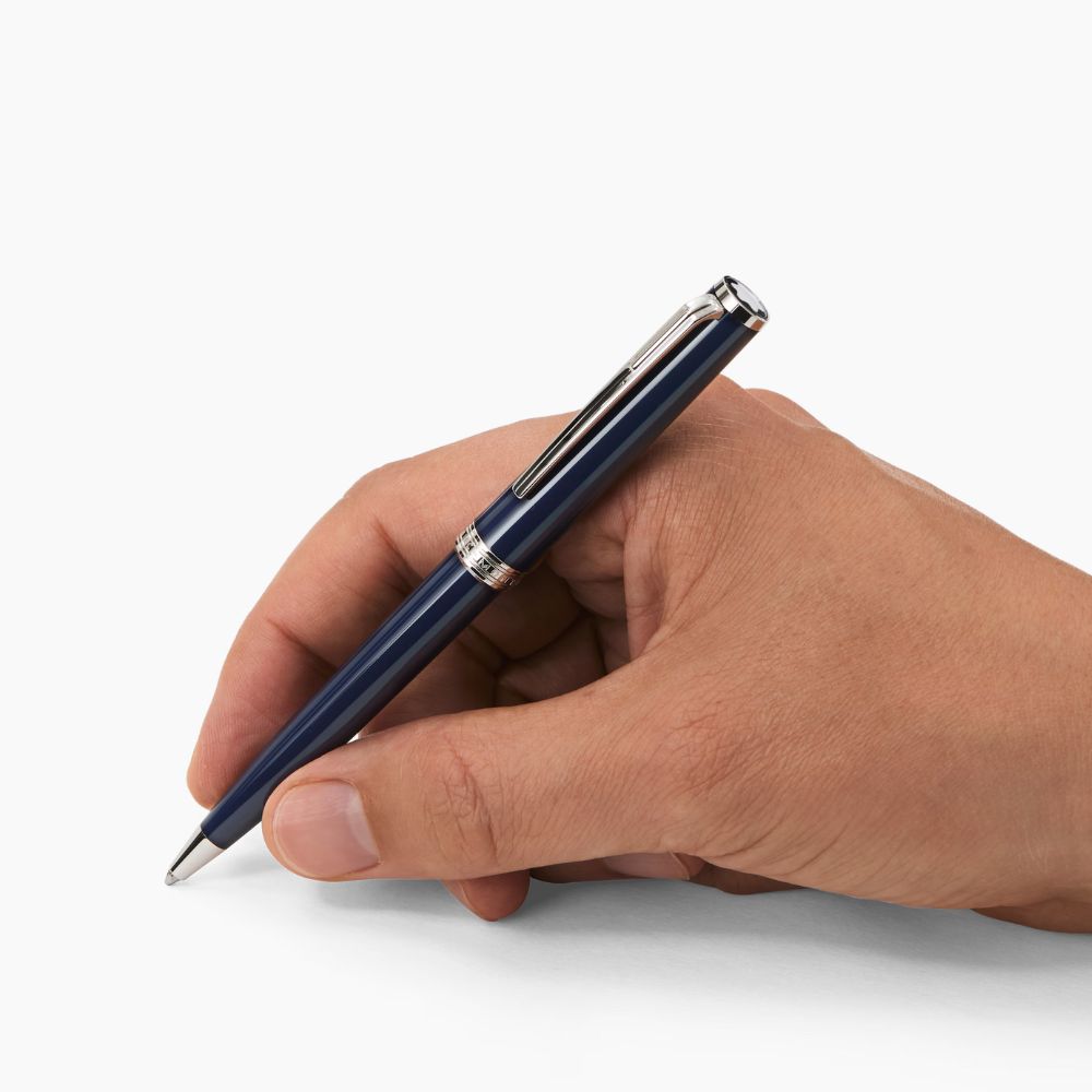 A hand holding a Montblanc Pix Blue Ballpoint Pen