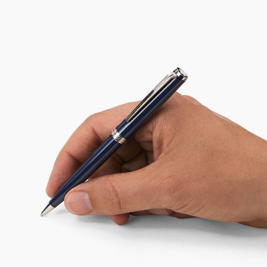 A hand holding a Montblanc Pix Blue Ballpoint Pen