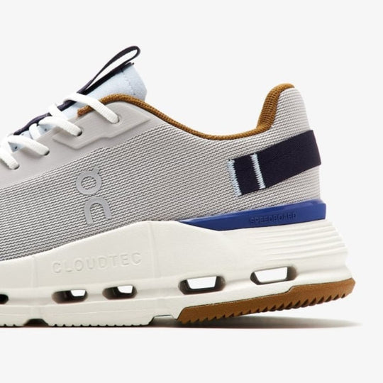 A detailed view of the back portion of the On Cloudnova Form 2 sneaker. The image showcases the grey mesh upper, the white midsole with visible CloudTec technology, and the brown rubber outsole.