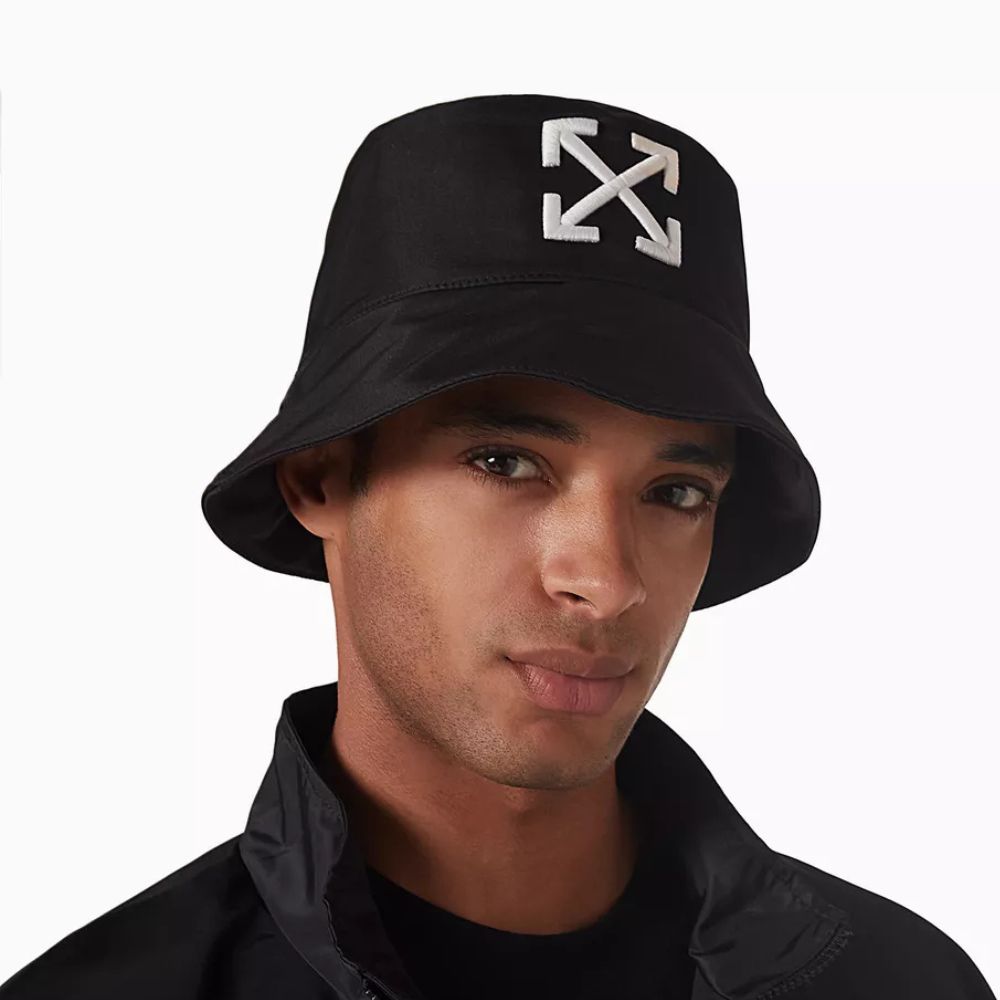 A model wearing Off-White Arrow Embroidered Black Nylon Bucket Hat