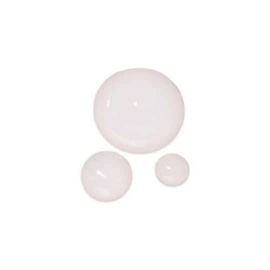 Three round, light pink drops of PEACE OUT SKINCARE Acne Serum on a white background.