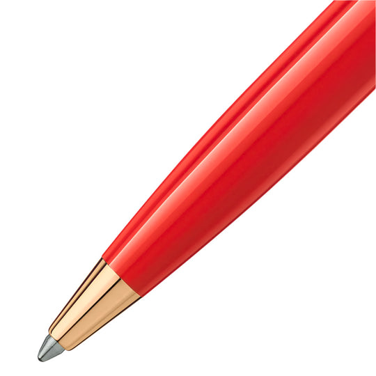 Close-up of a Montblanc PIX Modena red ballpoint pen tip, showing the red resin body, gold-tone band, and silver ballpoint.