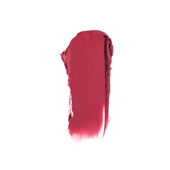 Swatch of matte pink lipstick on a white background.