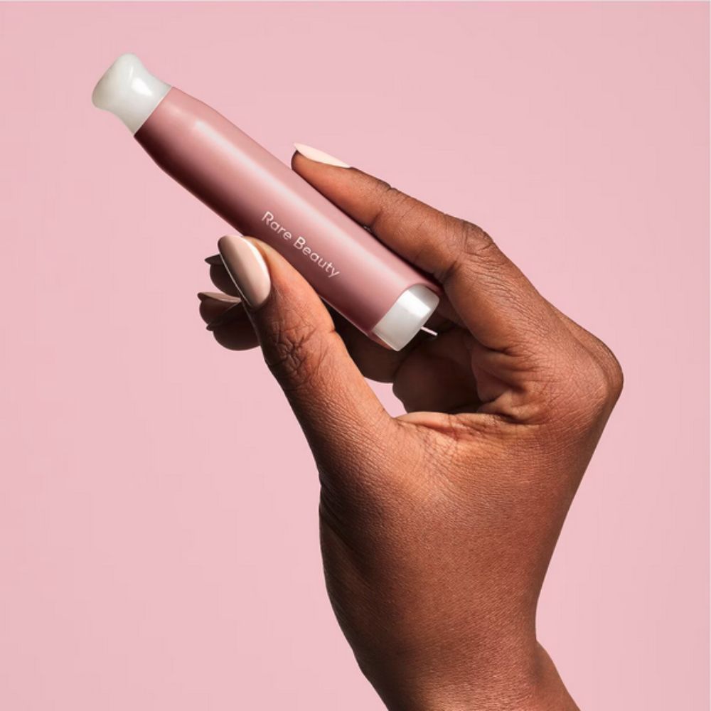 A hand holding RARE BEAUTY Find Comfort Stop & Soothe Aromatherapy Pen