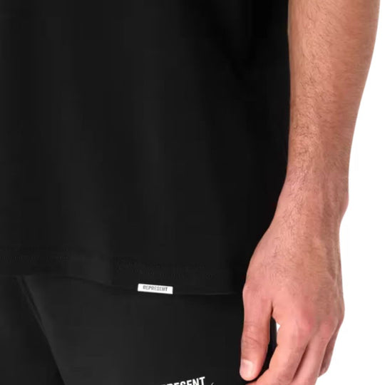 Close up view of the hem of REPRESENT Patron Of The Club T-Shirt worn by a male model