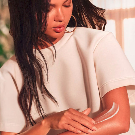 A model applying SOL DE JANEIRO Body Badalada™ Vitamin-Infused Lotion on her hand