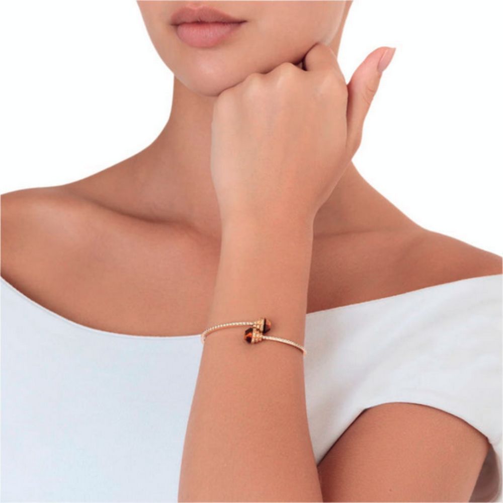 A model wearing Samra Azm Yellow Gold Tiger Eye Bangle
