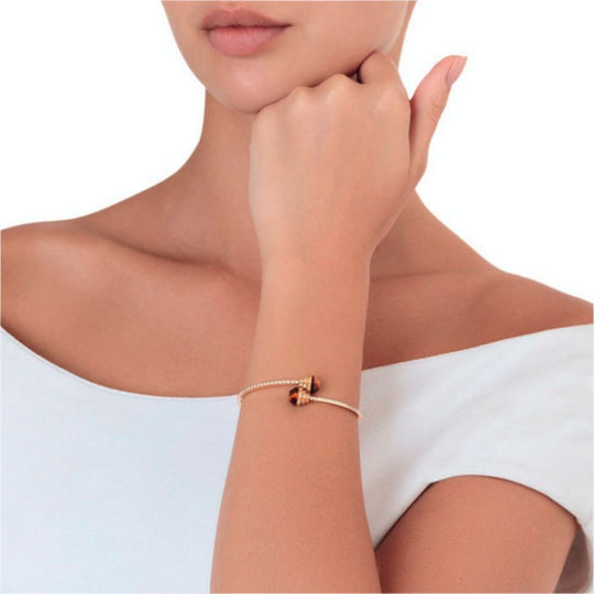 A model wearing Samra Azm Yellow Gold Tiger Eye Bangle