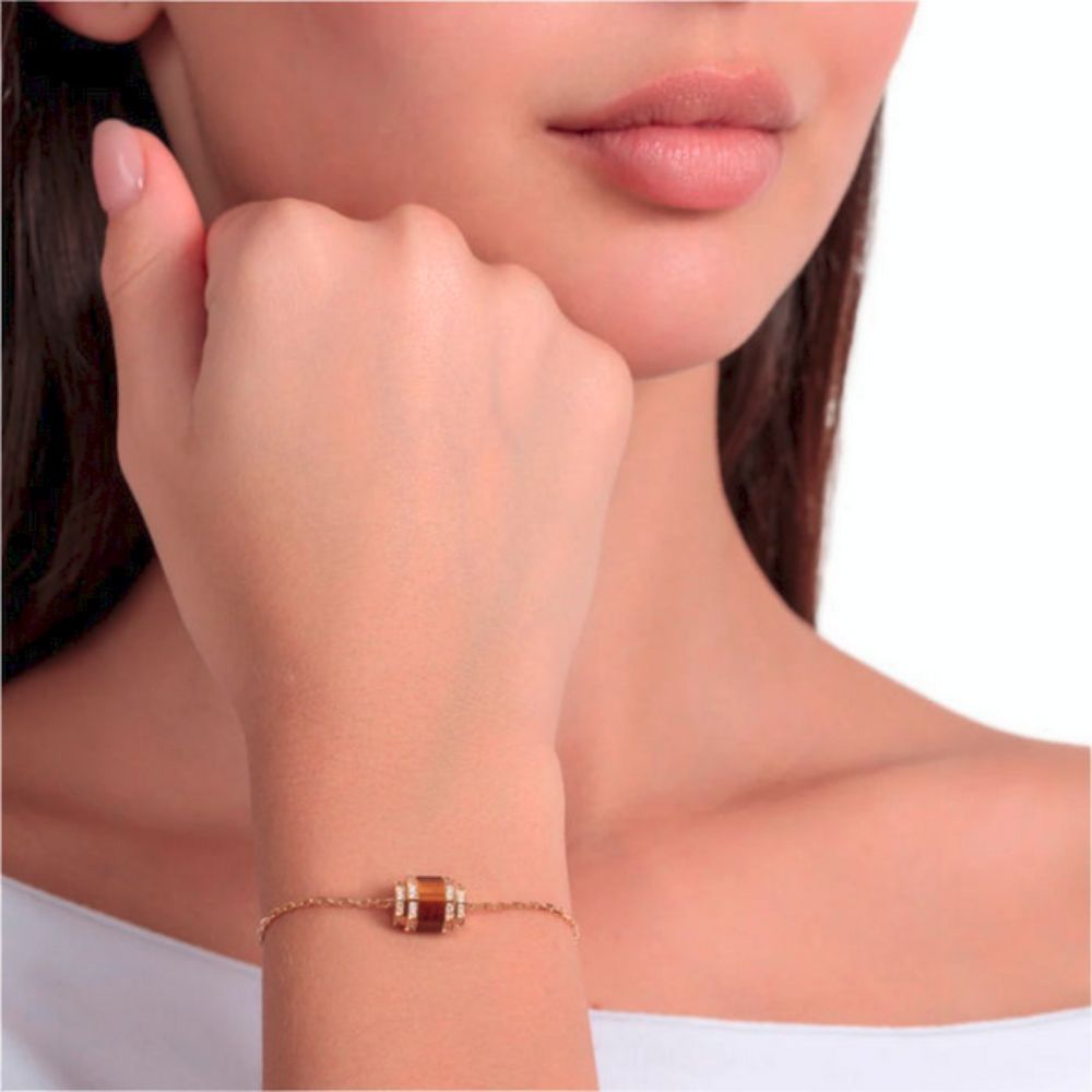 A model wearing Samra Azm Yellow Gold Tiger Eye Single Bracelet