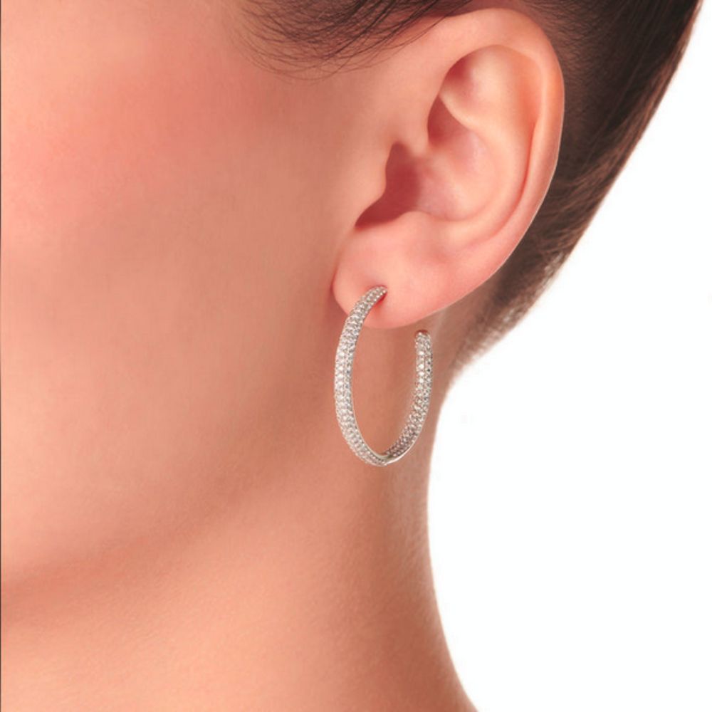 Close up of Samra Barq White Gold Diamond Medium Hoop Earring worn by a model