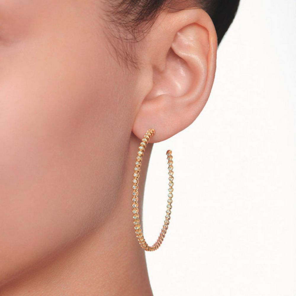 Close up of Samra Barq Yellow Gold Brilliant Diamond Large Hoop Earrings worn by a model